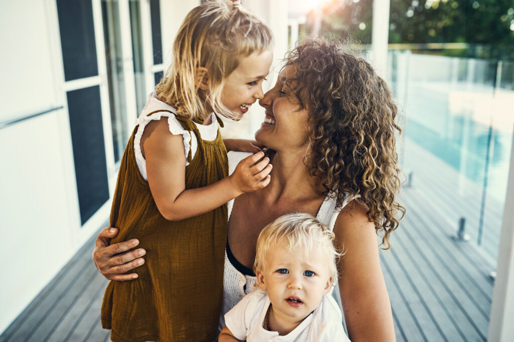 Shot of a mother bonding with her two young children at home